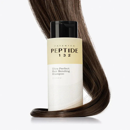 Shampoo bottle labeled 'Peptide 132' with a strand of brown hair on a white background