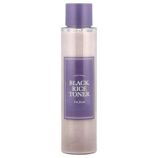 Bottle of black rice toner with a purple label on a white background