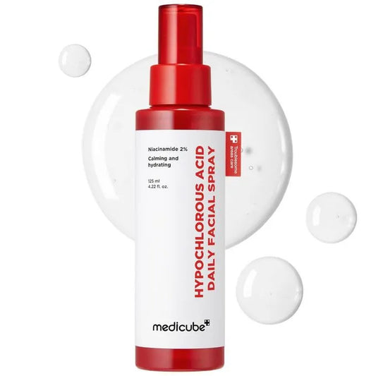 Facial spray bottle with red nozzle and white label on a white background