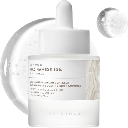 Skincare ampoule with dropper labeled 'Niacinamide 10%' on a white background
