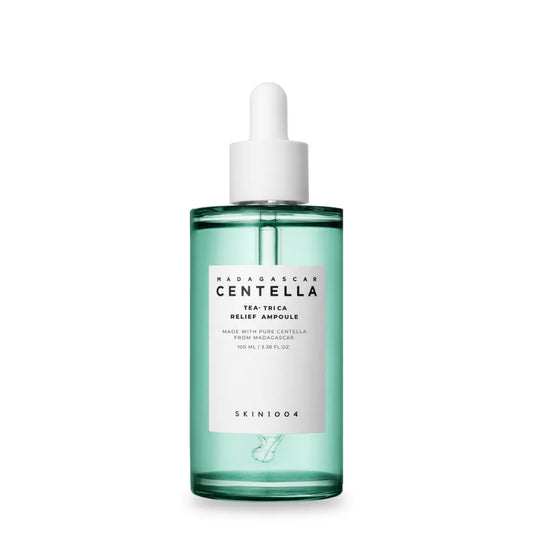 Skincare bottle with green liquid and white cap on a white background